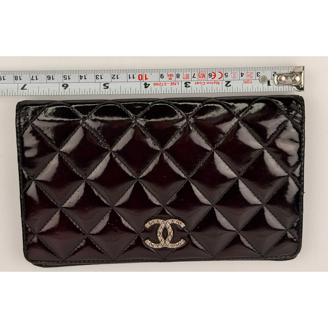 Chanel quilted patent leather long bifold wallet with a polished CC logo