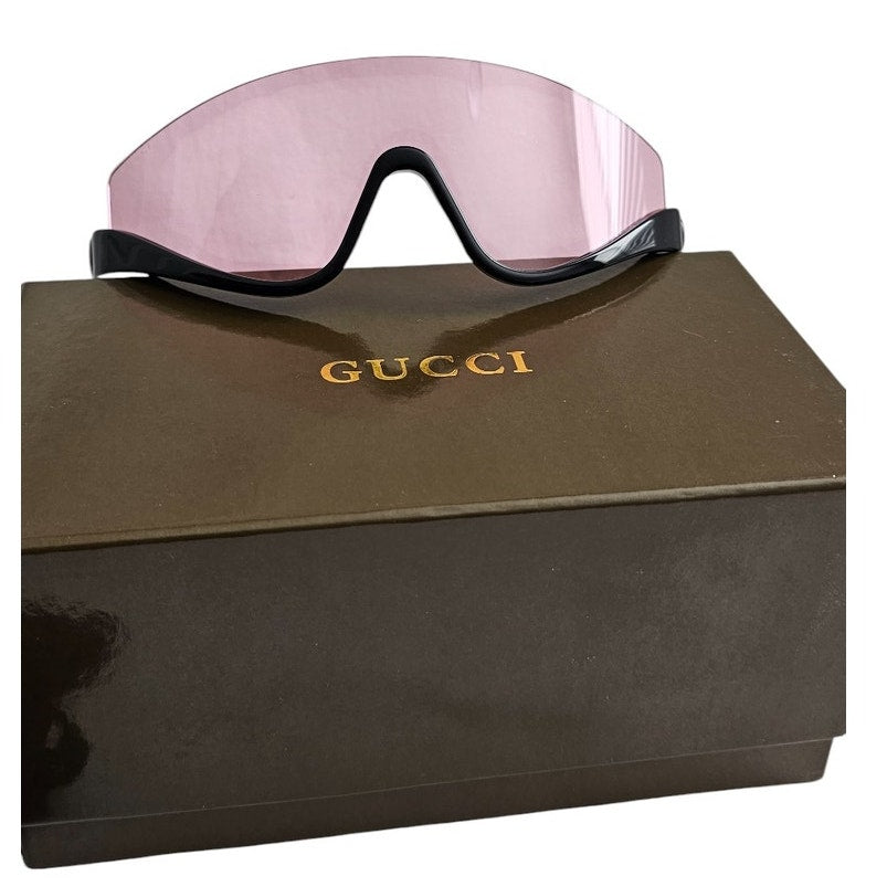 Gucci GG1650S 002 shield mask sunglass with a shiny black frame and pink bio-nylon lens