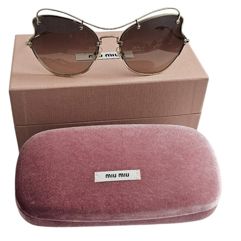 Miu Miu butterfly-style women's sunglasses with a pale gold-tone metal frame