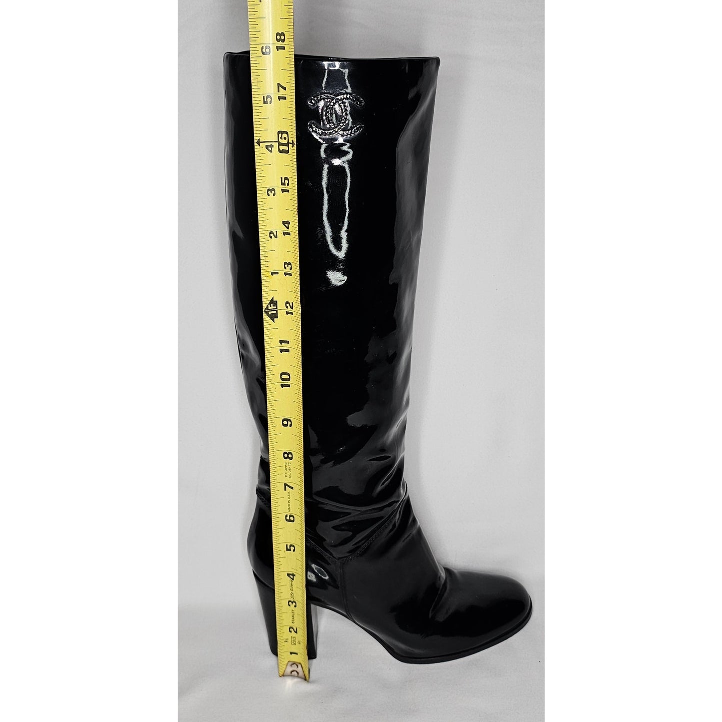 Chanel black patent leather boots with a chunky heel and embroidered CC logo
