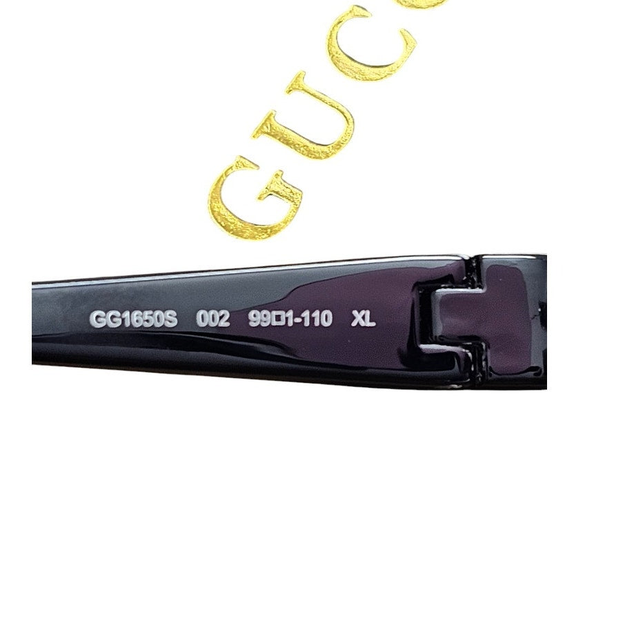 Gucci GG1650S 002 shield mask sunglass with a shiny black frame and pink bio-nylon lens