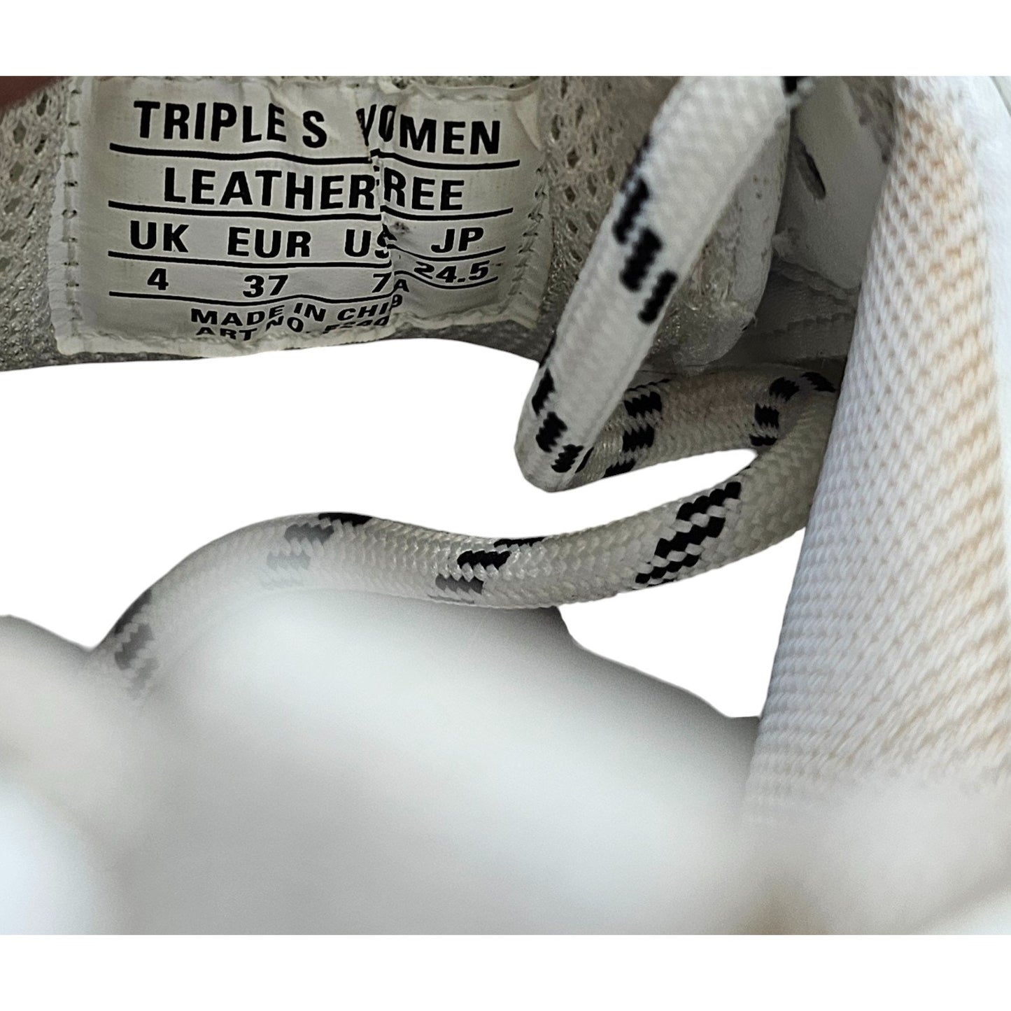 Balenciaga Triple S sneakers in white and black with pink accents and all-over logo detailing