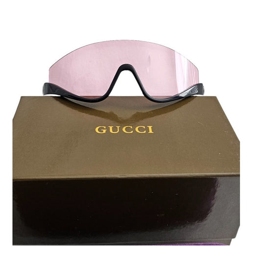 Gucci GG1650S 002 shield mask sunglass with a shiny black frame and pink bio-nylon lens